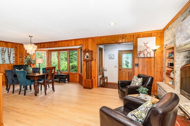 1350 Crestridge Ln, Eagan, MN 55123 - living area with wooden walls, a chandelier, ornamental molding, wood finished floors, and a fireplace