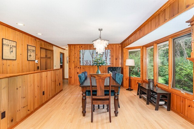 1350 Crestridge Ln, Eagan, MN 55123 - dining space featuring wood walls, ornamental molding, plenty of natural light, a chandelier, and light wood-type flooring