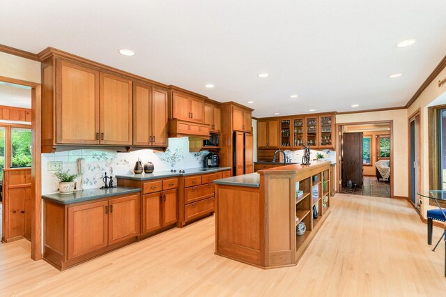 1350 Crestridge Ln, Eagan, MN 55123 - kitchen with light wood-style flooring, brown cabinetry, decorative backsplash, dark countertops, and recessed lighting