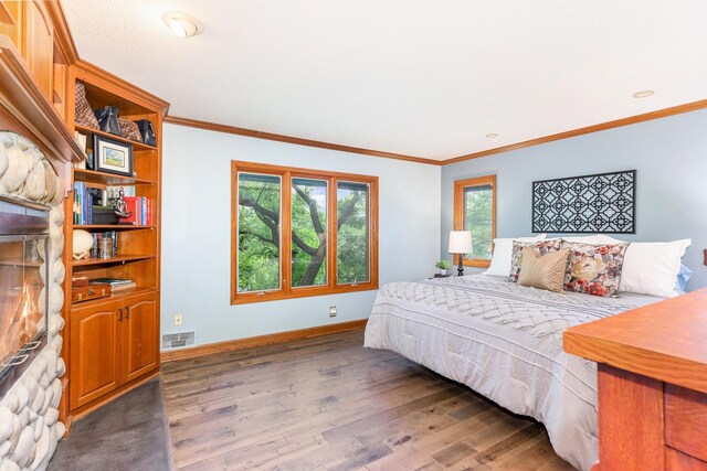 1350 Crestridge Ln, Eagan, MN 55123 - bedroom featuring wood finished floors, a fireplace, and crown molding
