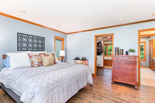 1350 Crestridge Ln, Eagan, MN 55123 - bedroom with light wood finished floors, ornamental molding, recessed lighting, and a spacious closet