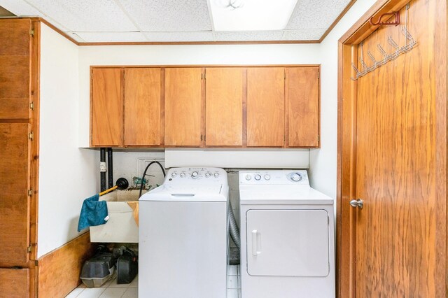 1350 Crestridge Ln, Eagan, MN 55123 - washroom with cabinet space, independent washer and dryer, crown molding, and tile patterned floors