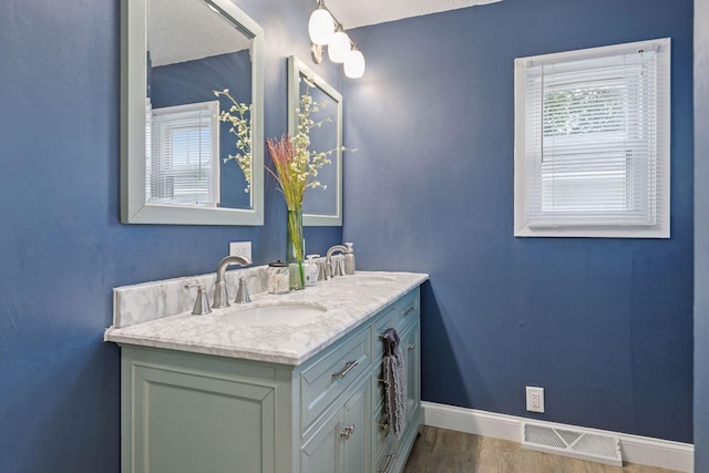 1475 Eldridge Ave E, Maplewood, MN 55109 - full bathroom featuring double vanity and wood finished floors