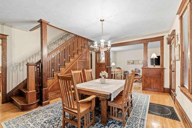 20930 St Francis Blvd NW, Nowthen, MN 55303 - dining space with stairs, light wood-type flooring, a chandelier, and ornamental molding