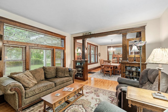 20930 St Francis Blvd NW, Nowthen, MN 55303 - living room featuring a chandelier, light wood-style floors, and decorative columns