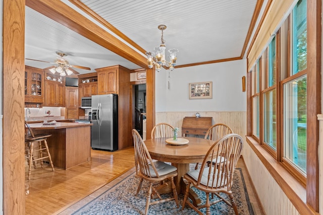 20930 St Francis Blvd NW, Nowthen, MN 55303 - dining space featuring ornamental molding, wainscoting, a chandelier, ceiling fan, and light wood-style flooring