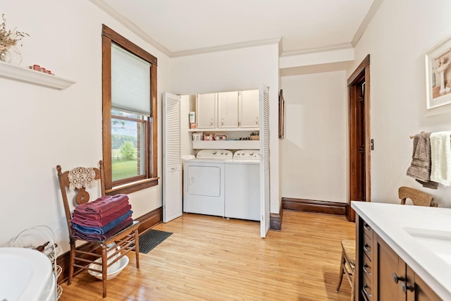 20930 St Francis Blvd NW, Nowthen, MN 55303 - washroom with cabinet space, washer and dryer, crown molding, and light wood-style flooring