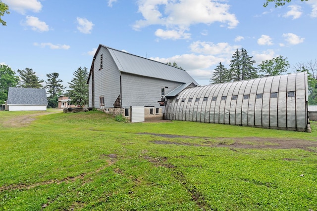 20930 St Francis Blvd NW, Nowthen, MN 55303 - view of side of property with a lawn, an outdoor structure, and a metal roof