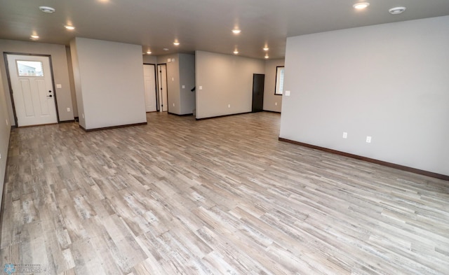 737 2nd Ave, Fargo, ND 58047 - unfurnished living room featuring light wood-style flooring, recessed lighting, and plenty of natural light