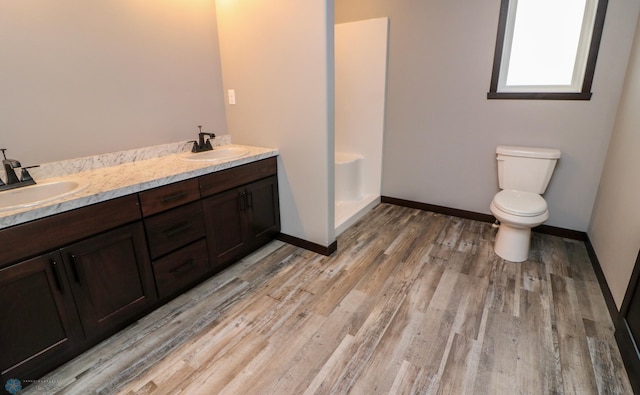 737 2nd Ave, Fargo, ND 58047 - full bathroom with wood finished floors, double vanity, and a shower