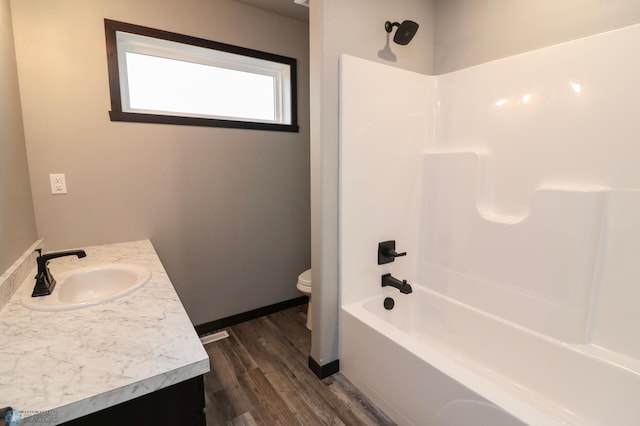 737 2nd Ave, Fargo, ND 58047 - bathroom featuring wood finished floors, vanity, and  shower combination