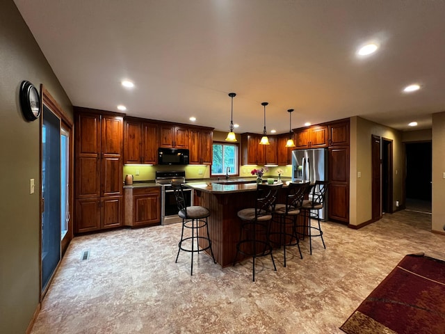 860 11th Ave, Granite Falls, MN 56241 - kitchen with appliances with stainless steel finishes, recessed lighting, a breakfast bar area, dark countertops, and a center island
