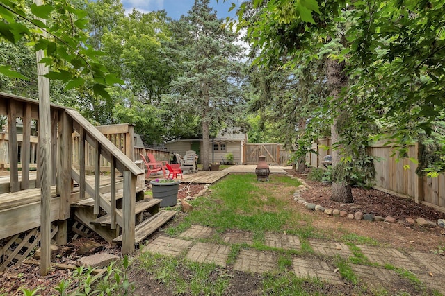 200 27th Ave N, Saint Cloud, MN 56303 - fenced backyard featuring a wooden deck and an outdoor fire pit