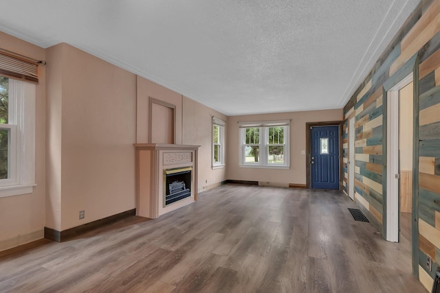 200 27th Ave N, Saint Cloud, MN 56303 - unfurnished living room featuring a fireplace, wood finished floors, and a textured ceiling