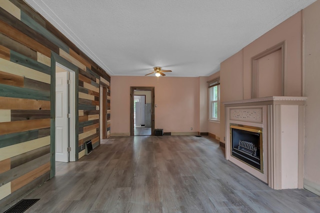 200 27th Ave N, Saint Cloud, MN 56303 - unfurnished living room with a fireplace, wood finished floors, ceiling fan, and a textured ceiling