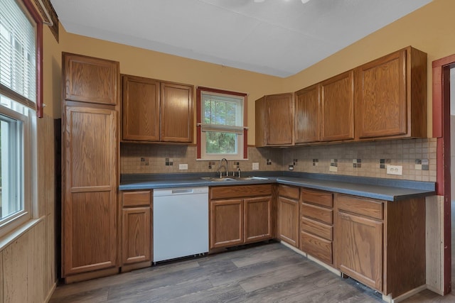 200 27th Ave N, Saint Cloud, MN 56303 - kitchen with white dishwasher, tasteful backsplash, dark countertops, wood finished floors, and brown cabinets