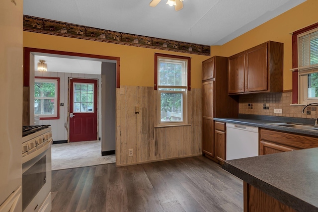 200 27th Ave N, Saint Cloud, MN 56303 - kitchen featuring white appliances, dark countertops, dark wood finished floors, decorative backsplash, and ceiling fan