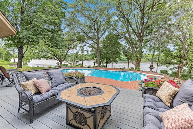 10810 Mississippi Blvd NW, Coon Rapids, MN 55433 - view of swimming pool with a deck, a fenced backyard, and an outdoor living space with a fire pit