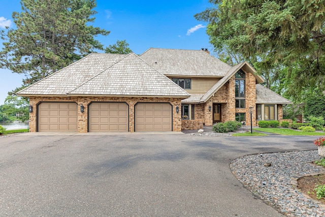 10810 Mississippi Blvd NW, Coon Rapids, MN 55433 - view of front of house with asphalt driveway, brick siding, and a garage