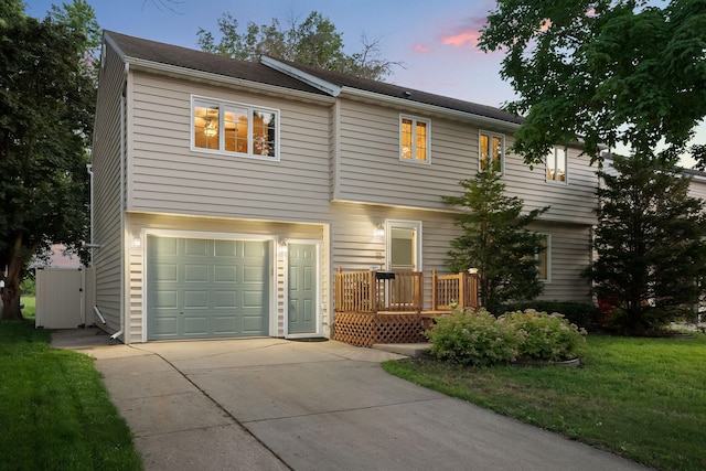 1218 4th Ave SE, Austin, MN 55912 - view of front of house with a garage, concrete driveway, and a lawn