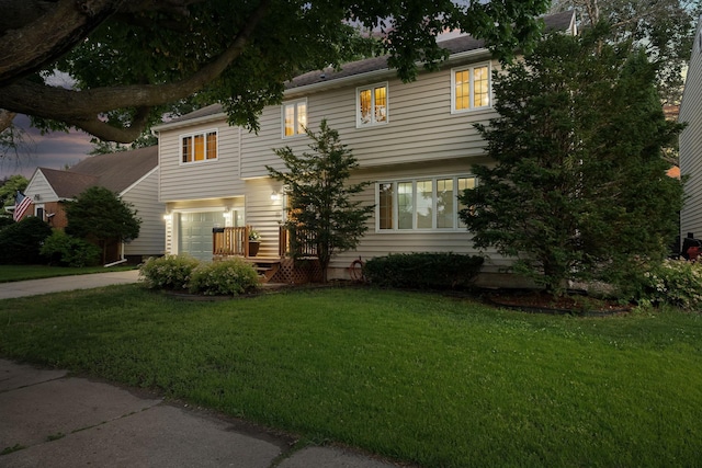 1218 4th Ave SE, Austin, MN 55912 - view of front of property with concrete driveway, a garage, and a front yard