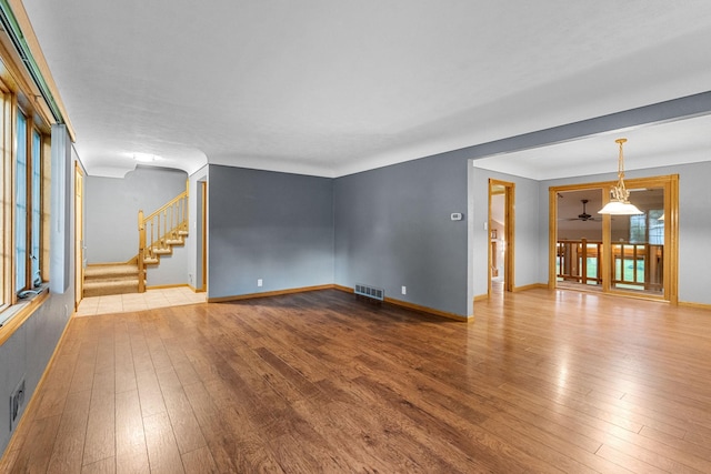 1218 4th Ave SE, Austin, MN 55912 - spare room with wood-type flooring and stairs