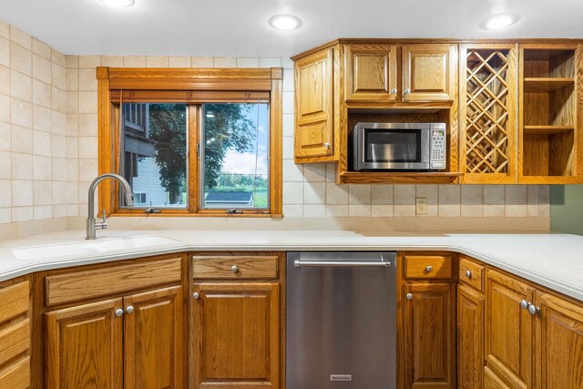 1218 4th Ave SE, Austin, MN 55912 - kitchen with appliances with stainless steel finishes, backsplash, light countertops, open shelves, and brown cabinetry