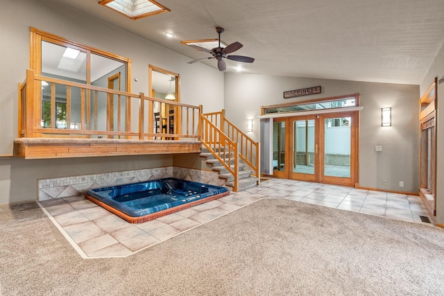 1218 4th Ave SE, Austin, MN 55912 - unfurnished living room featuring lofted ceiling, carpet floors, tile patterned floors, stairway, and a ceiling fan