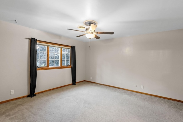 1218 4th Ave SE, Austin, MN 55912 - spare room featuring light carpet and ceiling fan