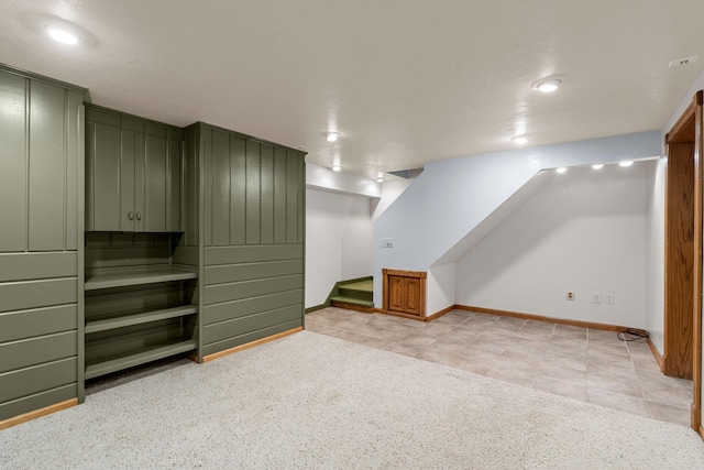 1218 4th Ave SE, Austin, MN 55912 - finished below grade area featuring stairs, light tile patterned floors, and light carpet