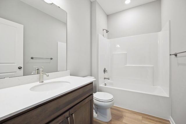 8007 Walnut Ln, Corcoran, MN 55340 - bathroom with wood finished floors, vanity, tub / shower combination, and recessed lighting