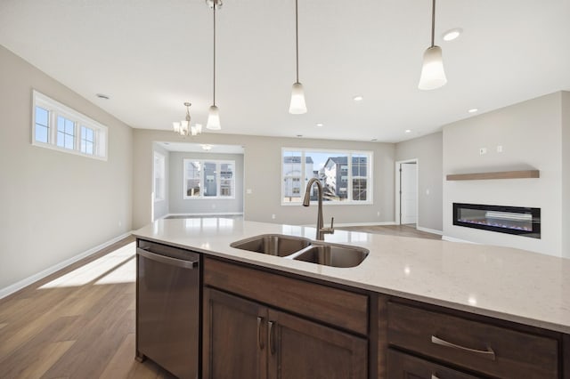 8007 Walnut Ln, Corcoran, MN 55340 - kitchen featuring stainless steel dishwasher, open floor plan, light wood-style floors, pendant lighting, and recessed lighting