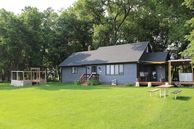 17718 705th Ave, Dassel, MN 55325 - back of house with roof with shingles, a lawn, and a chimney
