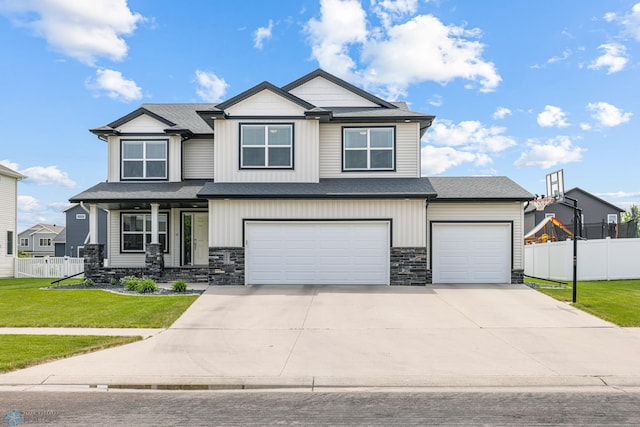 5480 Tanner Ave S, Fargo, ND 58104 - craftsman house featuring concrete driveway, stone siding, an attached garage, a porch, and roof with shingles