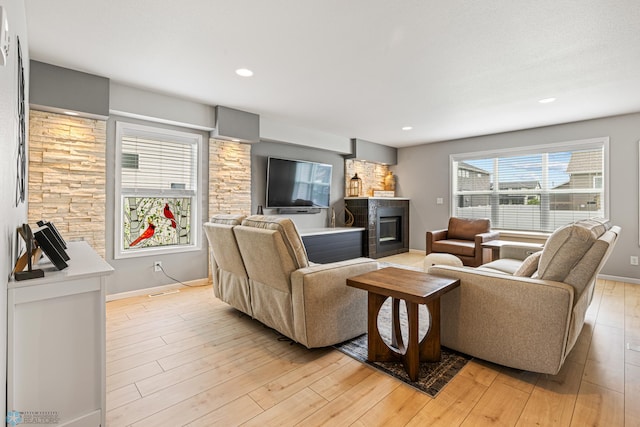 5480 Tanner Ave S, Fargo, ND 58104 - living room with a glass covered fireplace, light wood-type flooring, and recessed lighting