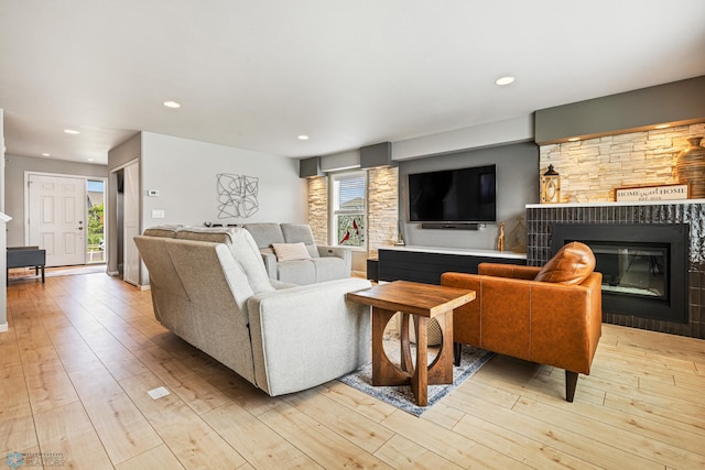 5480 Tanner Ave S, Fargo, ND 58104 - living room with light wood-type flooring, a glass covered fireplace, and recessed lighting