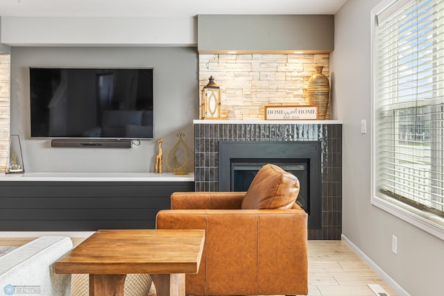 5480 Tanner Ave S, Fargo, ND 58104 - living area with plenty of natural light, a glass covered fireplace, and wood finished floors