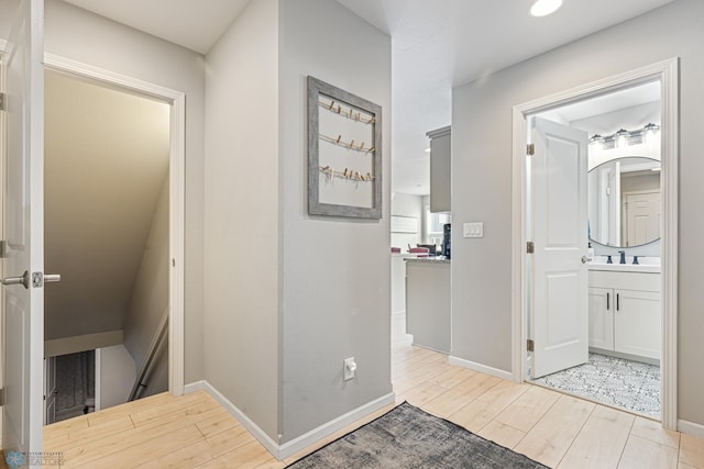 5480 Tanner Ave S, Fargo, ND 58104 - hallway featuring wood finished floors and an upstairs landing