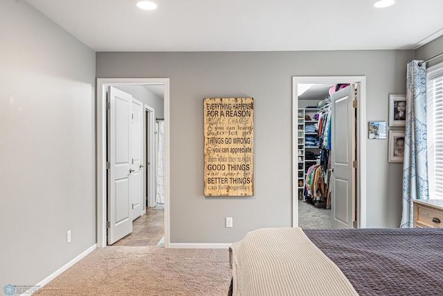 5480 Tanner Ave S, Fargo, ND 58104 - bedroom featuring light carpet, a walk in closet, recessed lighting, a closet, and multiple windows