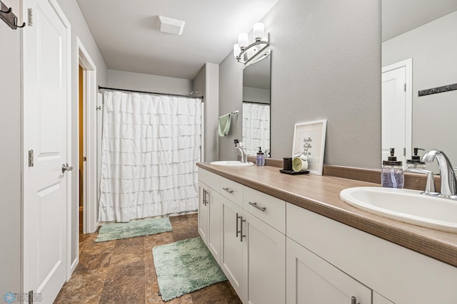 5480 Tanner Ave S, Fargo, ND 58104 - bathroom with double vanity, stone finish floors, and curtained shower