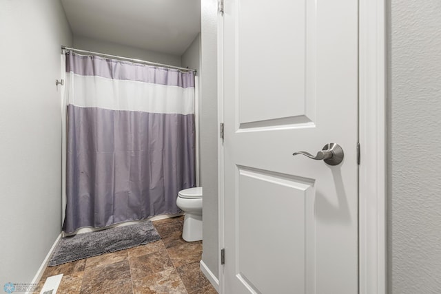 5480 Tanner Ave S, Fargo, ND 58104 - full bathroom with toilet and stone finish floors