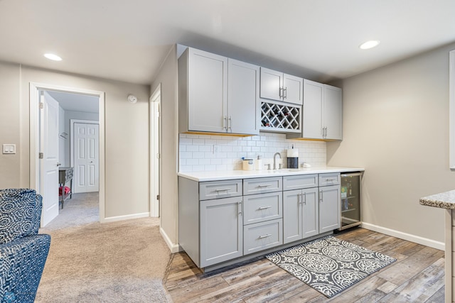5480 Tanner Ave S, Fargo, ND 58104 - kitchen featuring wine cooler, gray cabinetry, light countertops, decorative backsplash, and recessed lighting