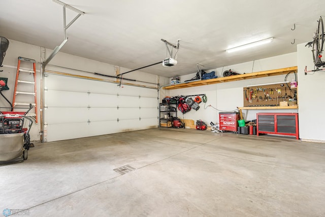 5480 Tanner Ave S, Fargo, ND 58104 - garage with a garage door opener and a workshop area