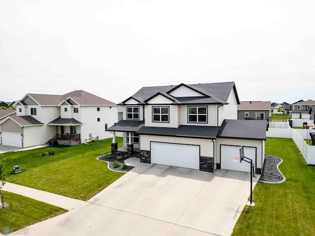 5480 Tanner Ave S, Fargo, ND 58104 - view of front of home featuring stone siding, concrete driveway, a residential view, a shingled roof, and an attached garage
