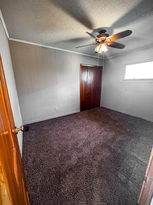 2284 15th St, Johnstown Twp, WI 54826 - unfurnished bedroom with carpet floors, a textured ceiling, a ceiling fan, and a closet