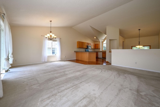 1212 Francis Dr, Elko New Market, MN 55054 - kitchen featuring stainless steel microwave, open floor plan, carpet flooring, healthy amount of natural light, and vaulted ceiling