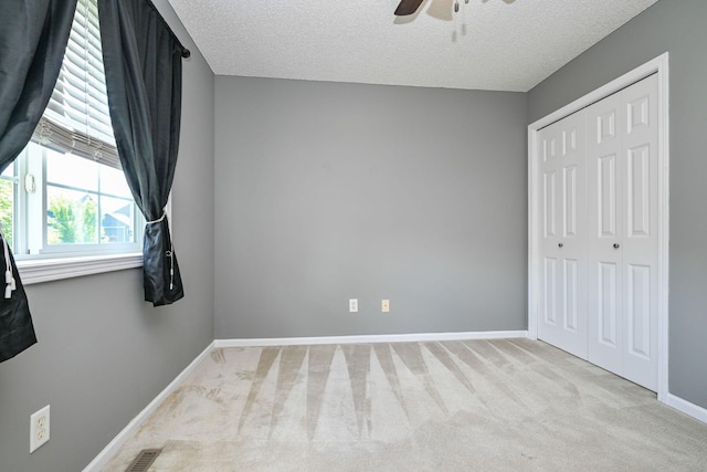 1212 Francis Dr, Elko New Market, MN 55054 - unfurnished bedroom featuring carpet floors, a closet, ceiling fan, and a textured ceiling