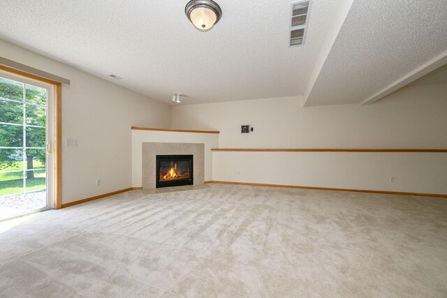 1212 Francis Dr, Elko New Market, MN 55054 - unfurnished living room with a textured ceiling, light colored carpet, and a tiled fireplace
