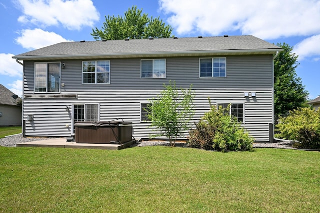 1212 Francis Dr, Elko New Market, MN 55054 - rear view of house featuring a hot tub, a lawn, and a patio area