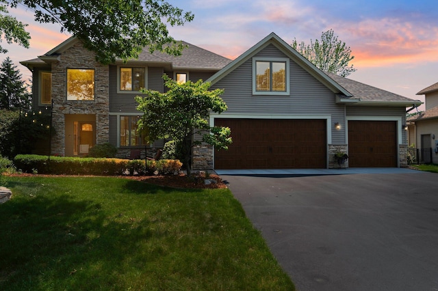 2334 Veterans Memorial Blvd NW, Andover, MN 55304 - view of front of property featuring stone siding, asphalt driveway, a front lawn, and a shingled roof